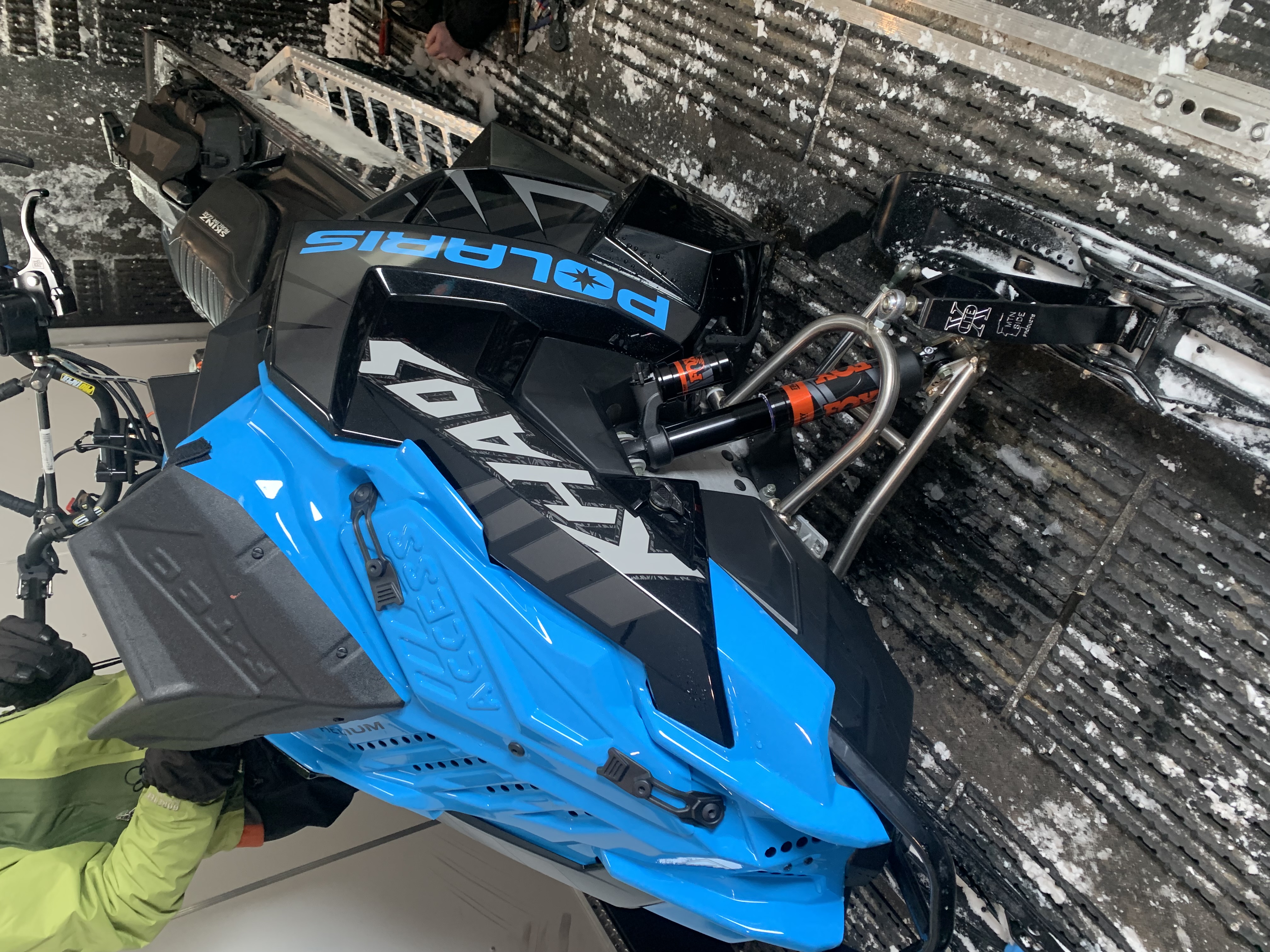Blue Polaris snowmobile suspension and service work