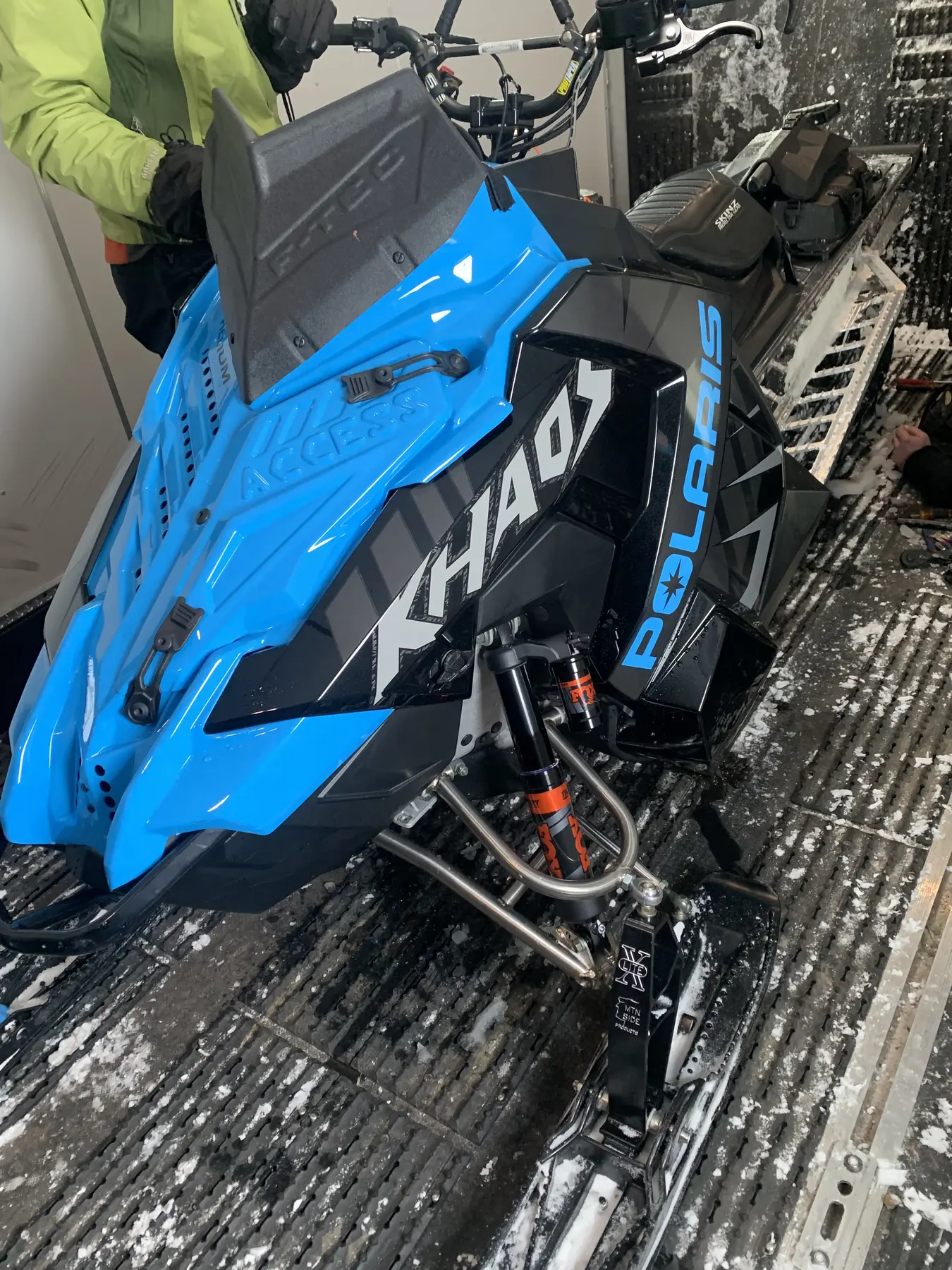 Blue Polaris snowmobile suspension and service work