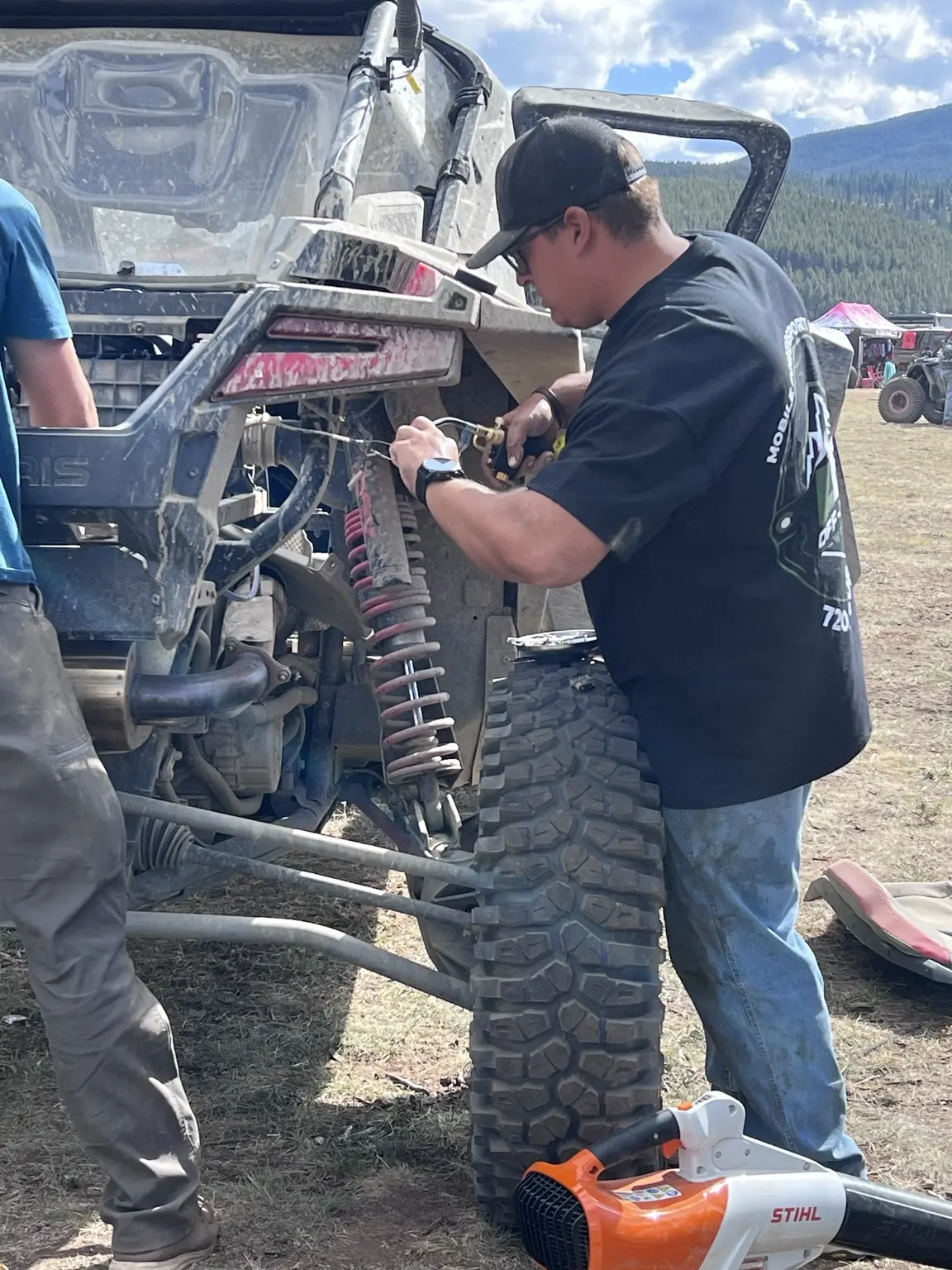 LB Off-Road Works technician performing mobile Polaris RZR repair at a Colorado off-road event