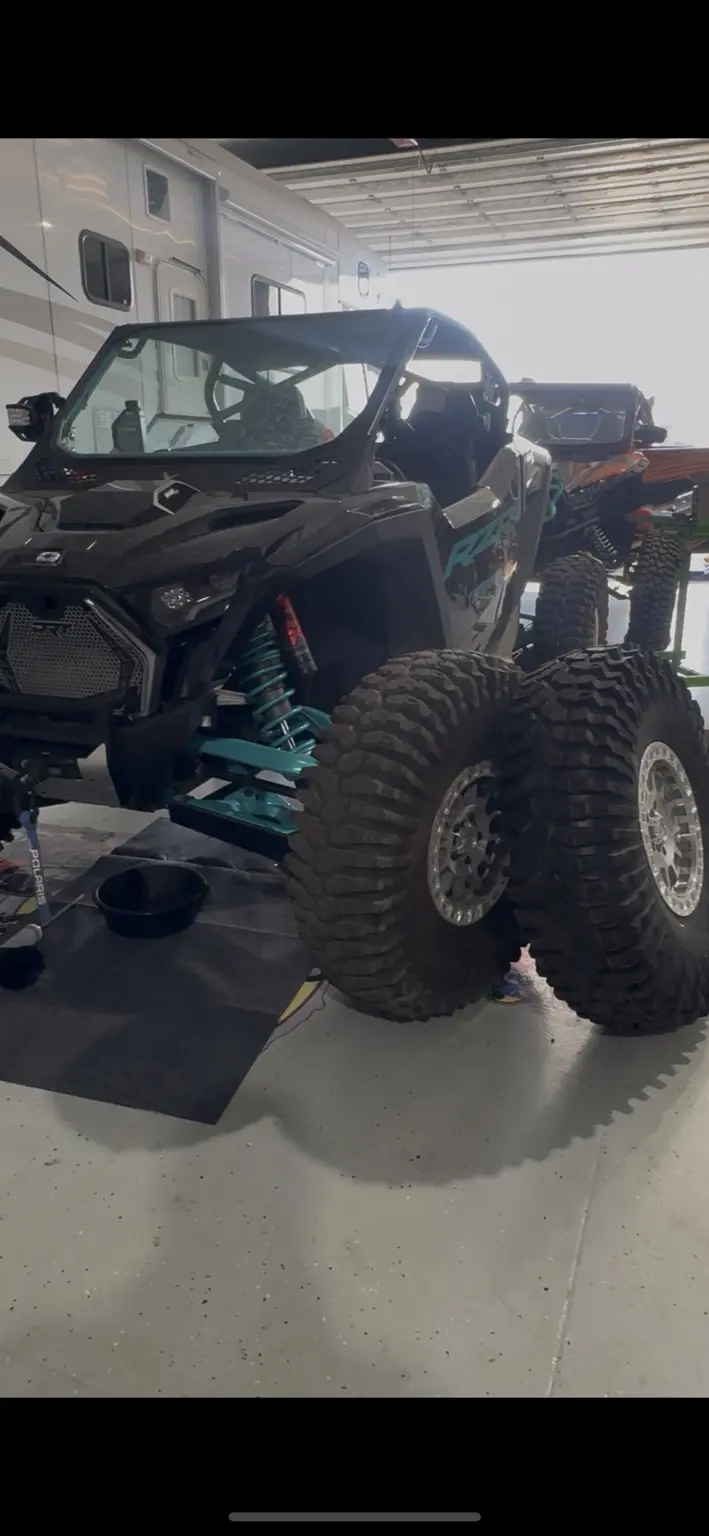 Polaris RZR undergoing professional maintenance in a Colorado powersports shop