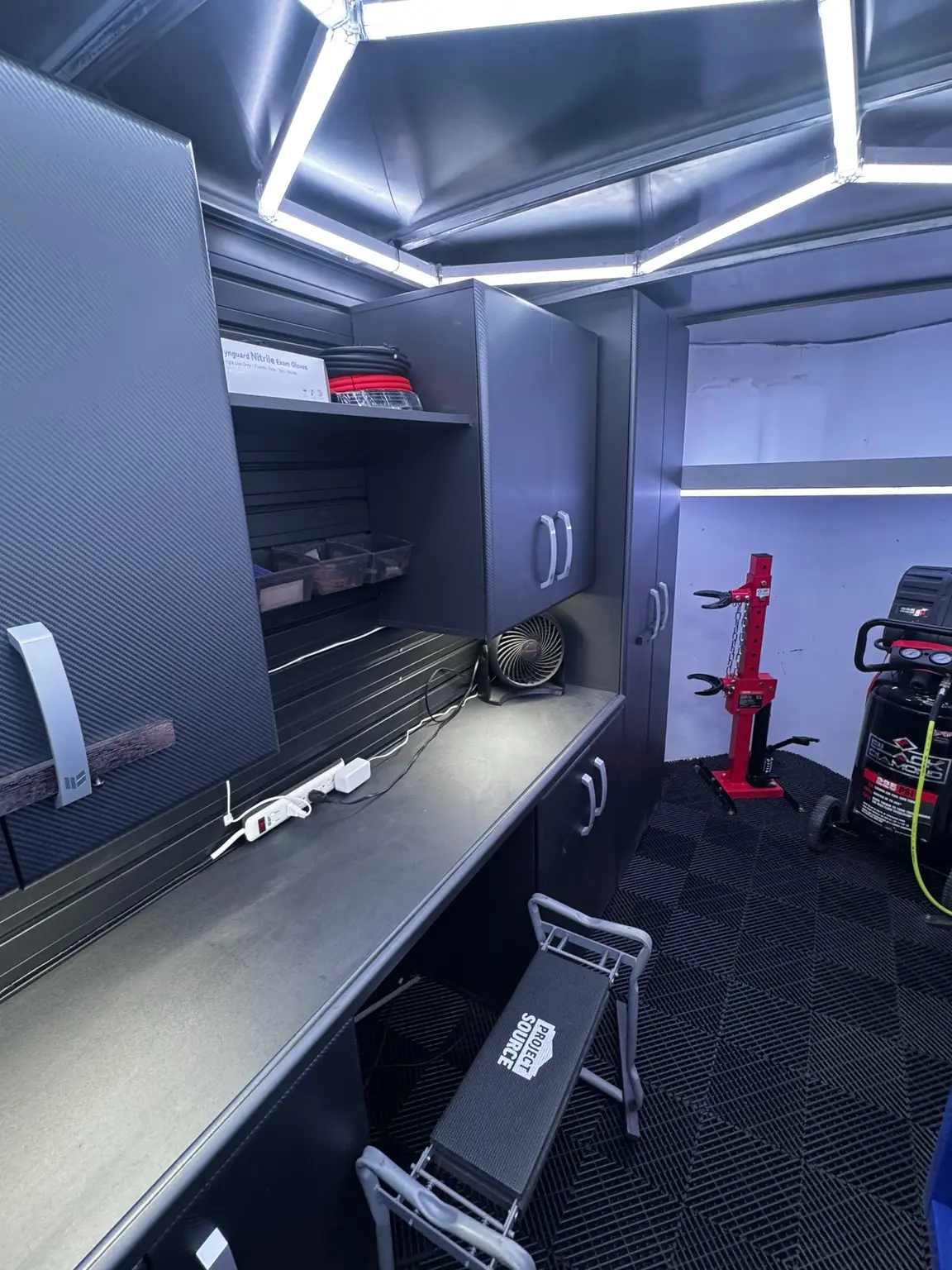 Dedicated red clutch spring compressor beside the workbench in the LB Off-Road Works trailer