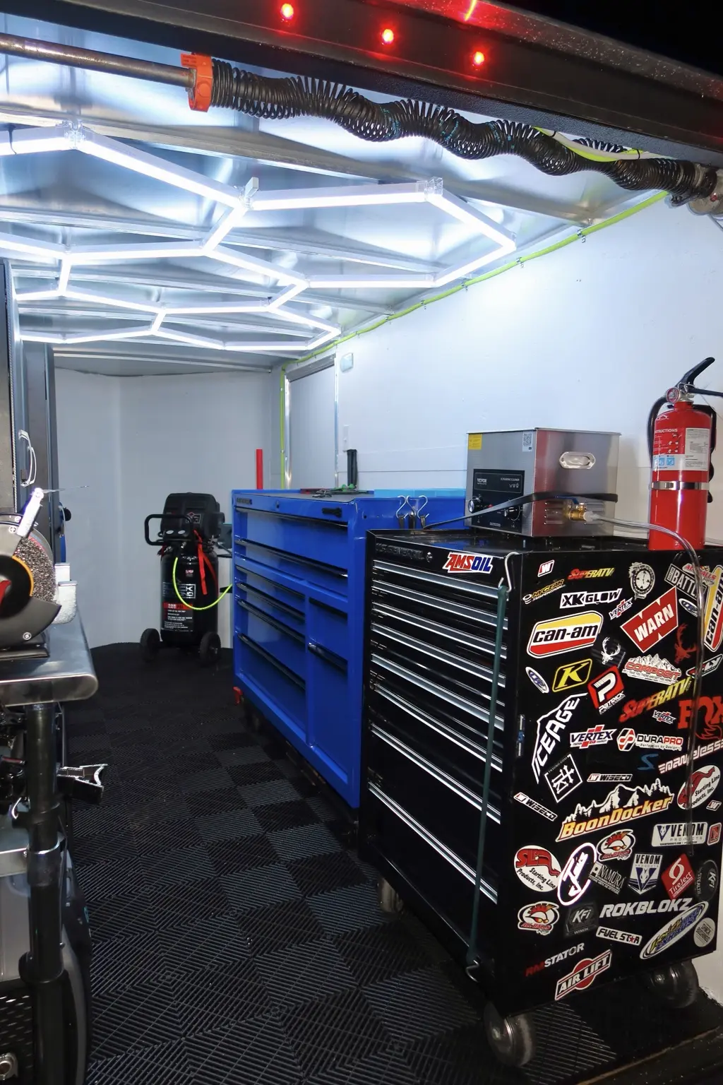Blue and black tool chests inside the LB Off-Road Works mobile shop