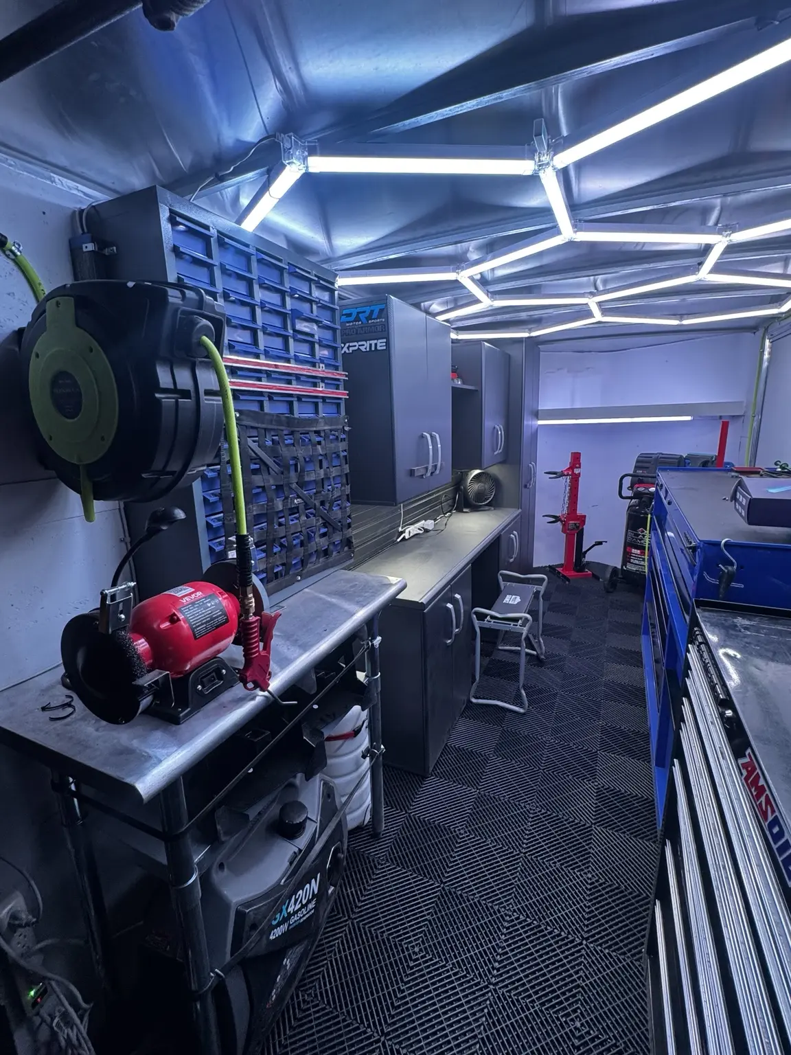 Workbench, cabinets, compressed air, and power equipment inside the mobile service trailer
